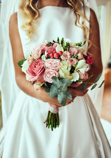 bouquet in hands of the bride, woman getting ready before wedding ceremony - 写真・画像