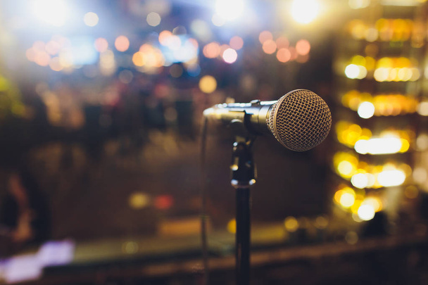 Close up microphone on stage in concert hall restaurant or conference room blurred background. - Фото, изображение