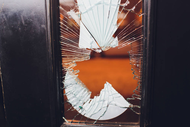 Broken glass black door of the shop. - Foto, afbeelding