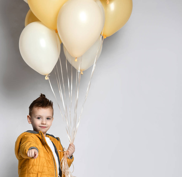 Cute kid holding a lot of balloons - Φωτογραφία, εικόνα