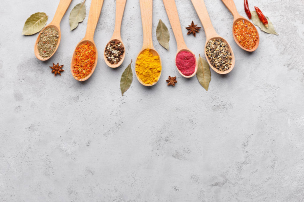 Mix of spices in wooden spoons, top view - Photo, Image