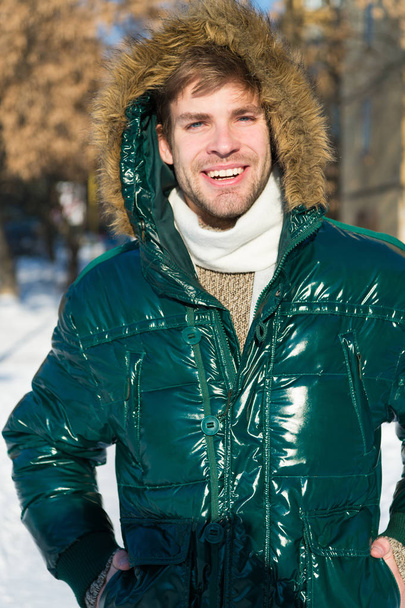 Man. It is cold outside. Forest in snow. Fresh air. Vacation and traveling. Happy man on winter holidays. Snowy weather. Trendy winter coat. Winter fashion. Warm clothes. Shopping in any weather - Fotoğraf, Görsel