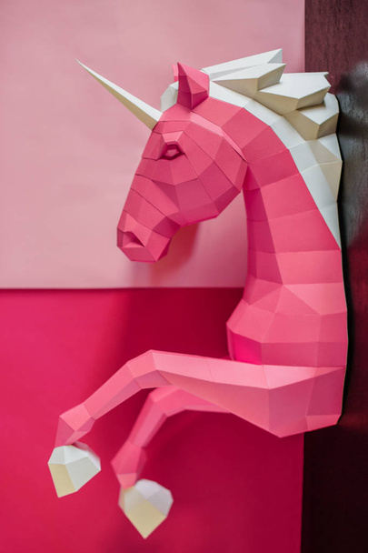 Paper unicorn head on a colored background. Geometry, bright and pastel colors. - Foto, imagen
