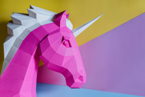 Paper unicorn head on a colored background. Geometry, bright and pastel colors. - Zdjęcie, obraz