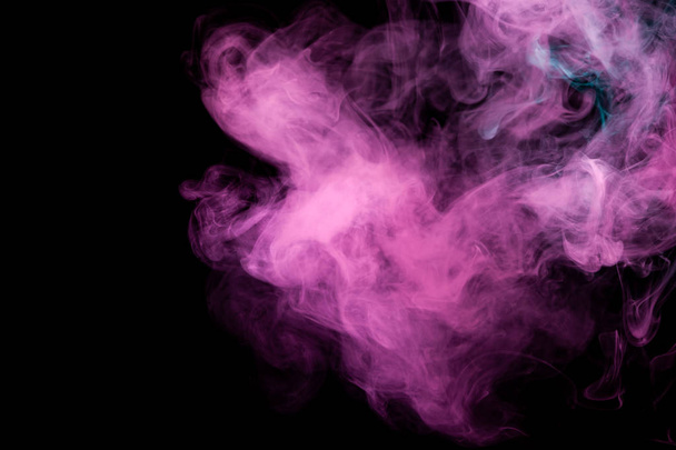 Thick pink and purple smoke on a black isolated background. Background from the smoke of vap - Fotoğraf, Görsel