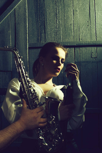 woman with microphone and man with sax - Fotoğraf, Görsel
