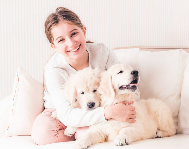 Smiling girl hugging puppies - Valokuva, kuva