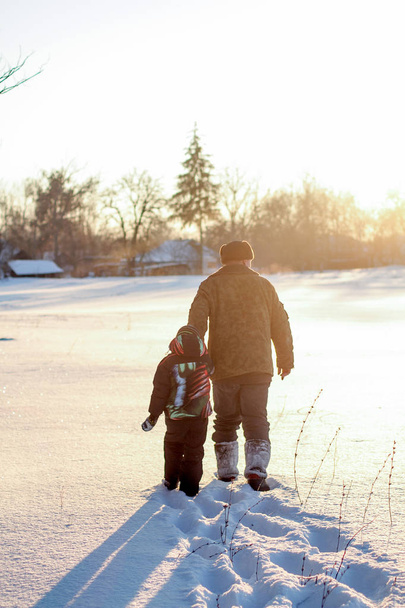Boy and grandfather enjoying the snow. Happy boy grandpa have winter fun - Photo, Image