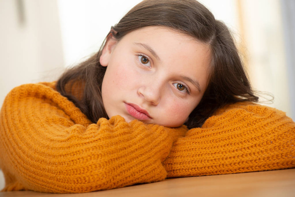 a young teenage girl with an yellow sweater - Фото, изображение