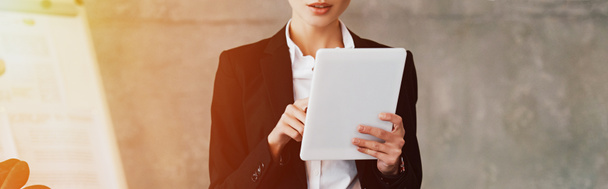 Cropped view of young businesswoman using digital tablet in office - Photo, Image