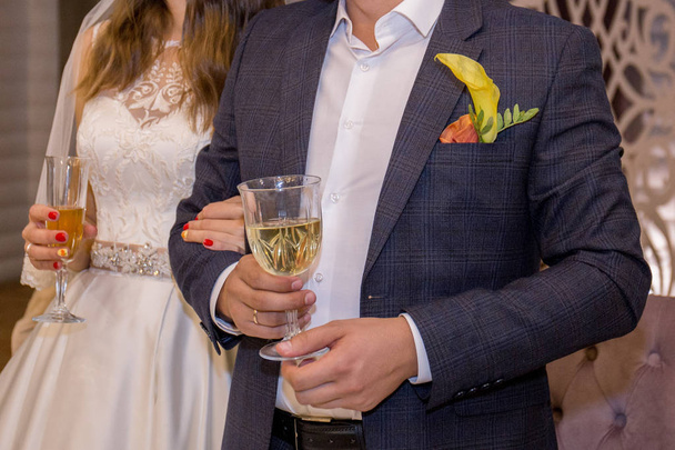 bride and groom in a restaurant hold wedding glasses - Zdjęcie, obraz