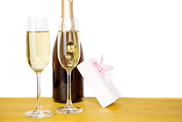 Бутылочное шампанское и два бокала с изолированной подарочной коробкой
 - Фото, изображение