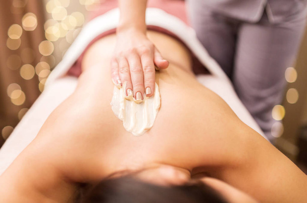 woman having back massage with cream at spa - Φωτογραφία, εικόνα