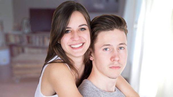 couple hugging sitting on couch at home - Foto, Imagen