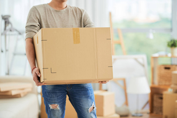 man carrying large cardboard box on moving day  - Photo, Image