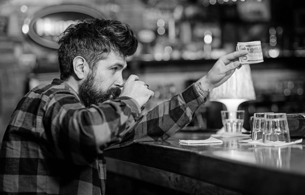 Alcohol addicted concept. Hipster holds glass with alcoholic drink - Фото, зображення