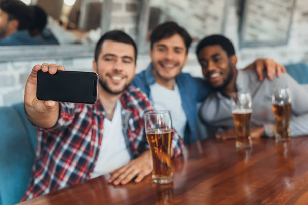 男性 selfie をとり、ビールを飲みながらバーで - 写真・画像