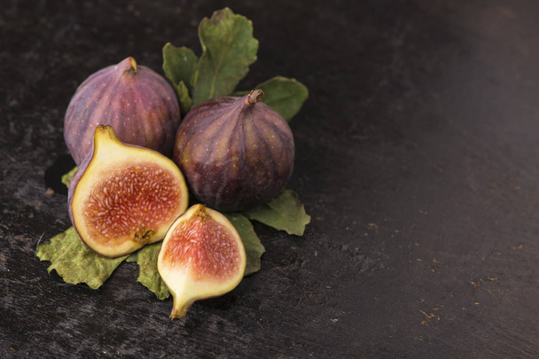 Fresh figs on black background close up - Foto, afbeelding