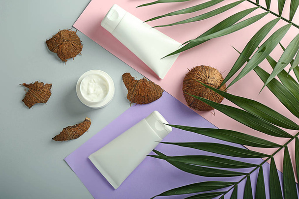 Cream, palm leaves and coconut on color background - Fotografie, Obrázek