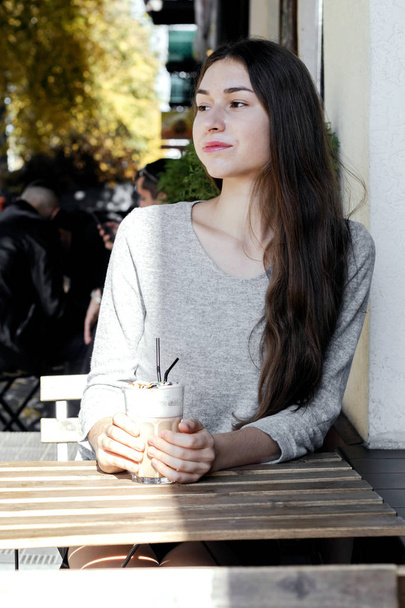 Girl in cafe drinking coffee. - Фото, зображення