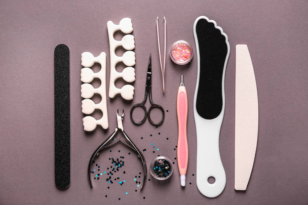 Set of pedicure tools on grey background - 写真・画像