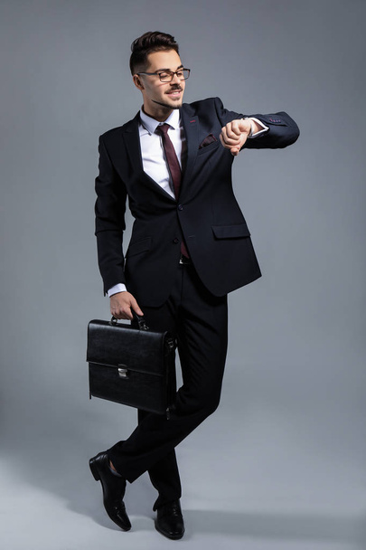 Stylish businessman on grey background - 写真・画像