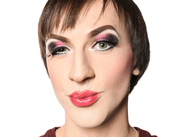 Portrait of transgender man with bright makeup on white background - Foto, imagen