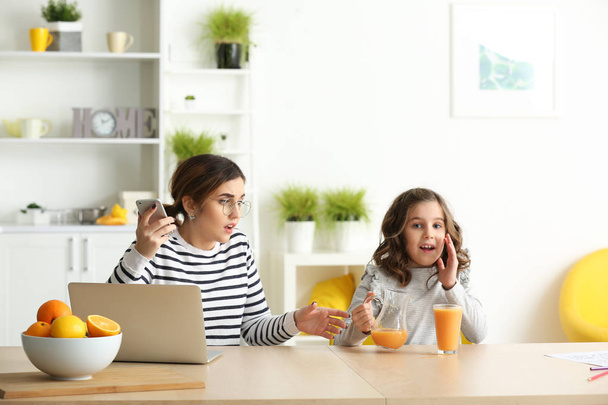 Stressed mother with naughty daughter working at home - Photo, Image