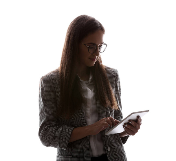 Silhouette of beautiful businesswoman with tablet computer on white background - Fotó, kép