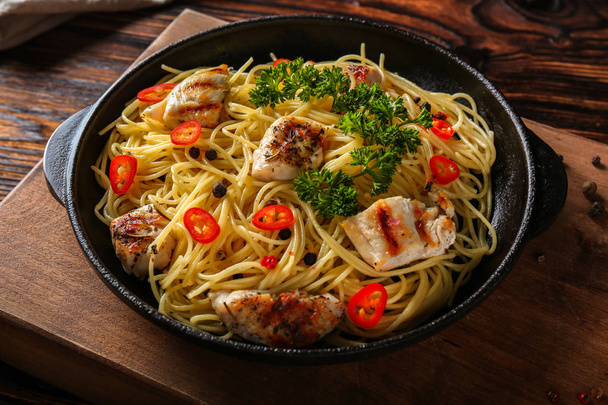 Tasty pasta with chicken and vegetables in frying pan - Photo, Image