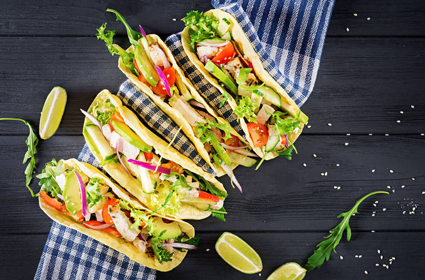 Mexican tacos with chicken meat, avocado, tomato, cucumber and red onion. Healthy tortilla. Wrap food. Taco. Top view - Φωτογραφία, εικόνα