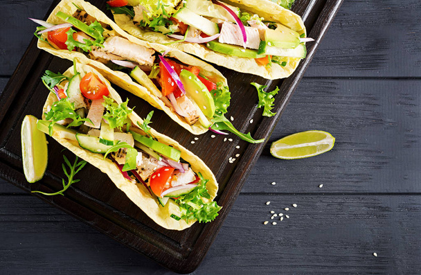 Mexican tacos with chicken meat, avocado, tomato, cucumber and red onion. Healthy tortilla. Wrap food. Taco. Top view - Photo, Image