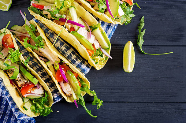 Mexican tacos with chicken meat, avocado, tomato, cucumber and red onion. Healthy tortilla. Wrap food. Taco. Top view - Photo, Image