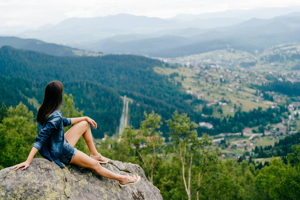 back view of lonely young traveller with beautiful mountains on background - Foto, Imagen