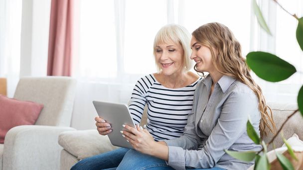 Senior mother and daughter using tablet, watching video - Photo, image