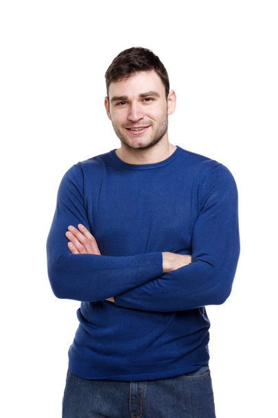 Hombre guapo usando un suéter azul aislado en blanco
 - Foto, imagen