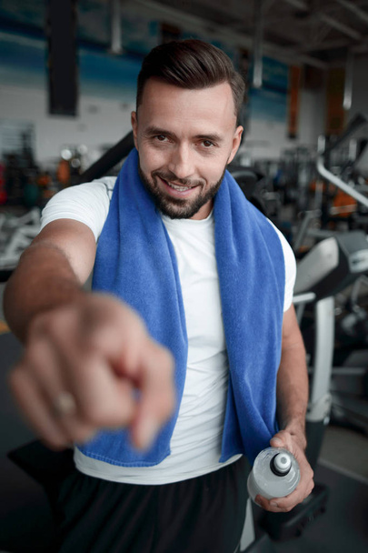 close up.confident sports man pointing at you - Фото, изображение