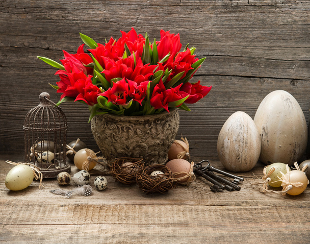 vintage easter decoration with eggs and red tulips - 写真・画像