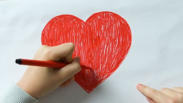 Little kid drawing big red heart and making word love of cubes, kindness, peace - Materiał filmowy, wideo