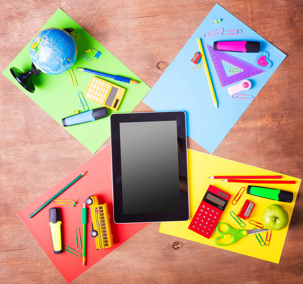Tablet pc, notebook stack and pencils. Schoolchild and student studies accessories. Back to school concept. - Photo, image