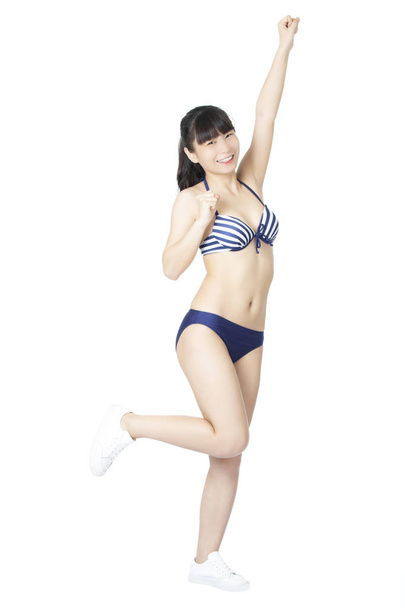 Beautiful Chinese woman wearing a sexy bikini isolated on a white background - Foto, imagen