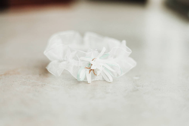 Wedding garter on a white background bridal accessory - Fotografie, Obrázek