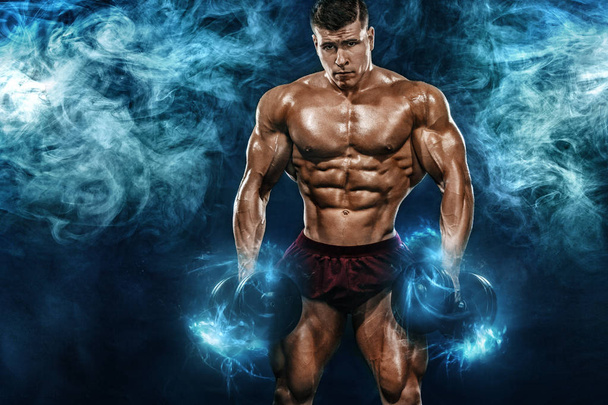 Brutal strong muscular bodybuilder athletic man pumping up muscles with dumbbell on black background. Workout bodybuilding concept. Copy space for sport nutrition ads. - Foto, Imagen