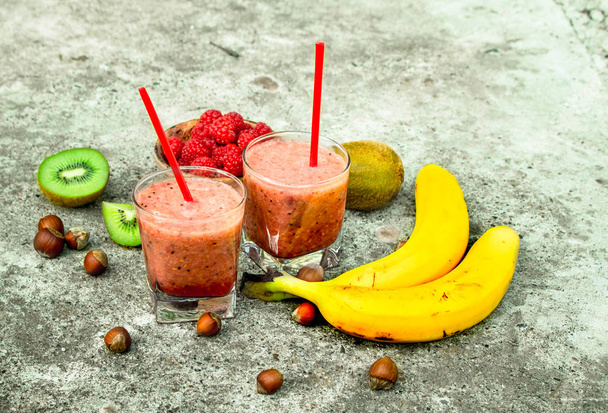 Fruit smoothie in glasses. On rustic background. - Photo, image