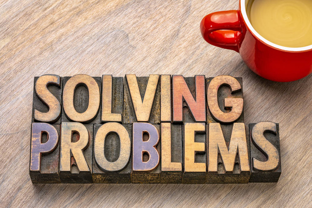 solving problems  word abstract in vintage letterpress wood type printing blocks with a cup of coffee - Photo, Image