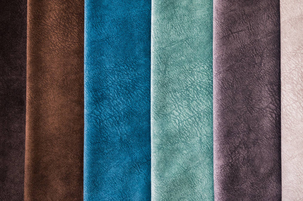 Colorful and bright fabric samples of furniture and clothing upholstery. Close-up of a palette of textile abstract stripes of different colors - Фото, изображение