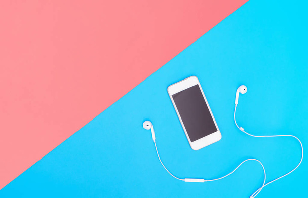 Empty Mobile phone screen with Music earphone on blue copy space for poster and text - Fotoğraf, Görsel
