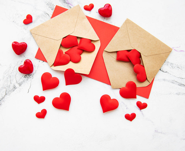 Valentines day romantic background - envelopes with decorative hearts on a marble background - Photo, Image