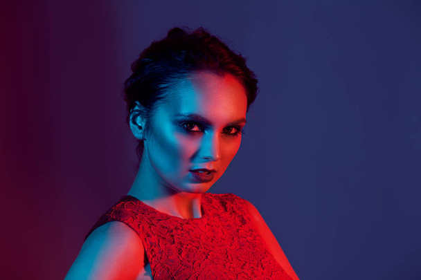 elegant girl with bright makeup with color light - Фото, зображення