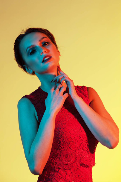 elegant girl touching her neck with colored light - Φωτογραφία, εικόνα
